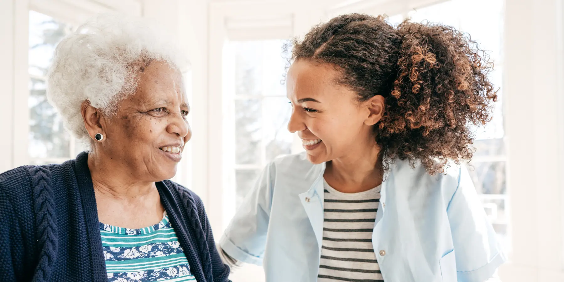 Social worker helping an elderly woman