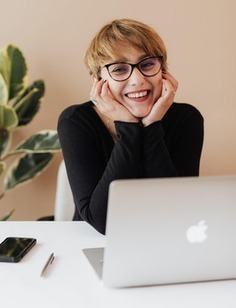 smiling online student with a laptop, Adelphi online MSW