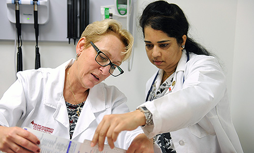 Two medical professionals looking at a report