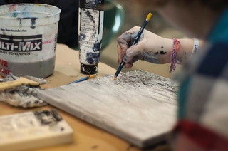 Close up of someone painting on canvas