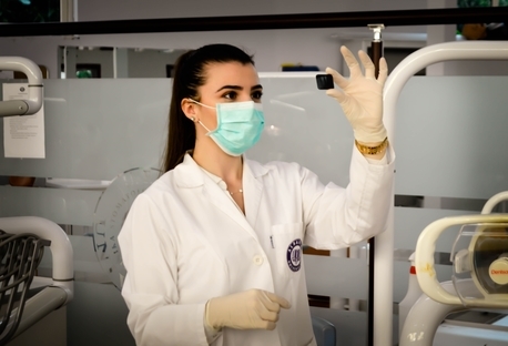 Nurse wearing gloves and a mask