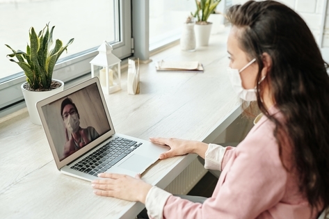 A person using a laptop for a video call